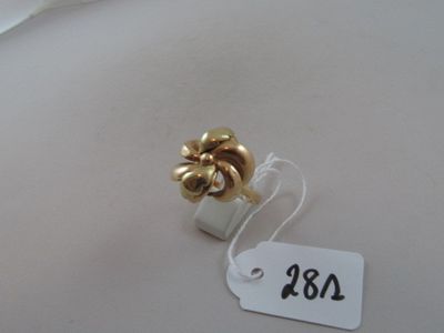 a gold ring with a flower on top of it