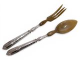 two forks and spoons are sitting next to each other on a white surface