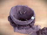 a large stone bowl with a bird nest inside of it