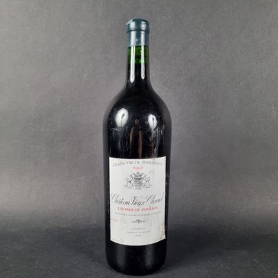 a picture of a bottle of red wine on a grey background