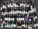 many bottles of wine sitting on the floor next to each other
