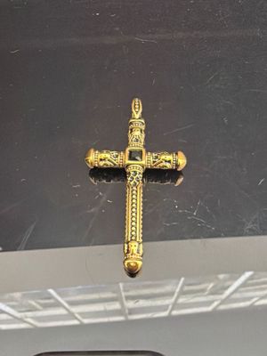 a gold cross hanging from the ceiling of a car