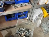 many different types of screws and nuts on the shelves