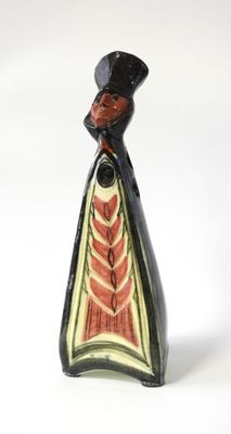 un petit vase noir et rouge surmonté d'un oiseau