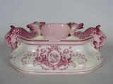 a pink and white vase with two fish on it