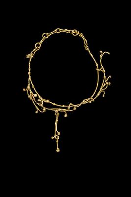 a gold bracelet with a chain and a cross on it