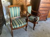 two chairs with striped upholstered upholstered cushions in a room