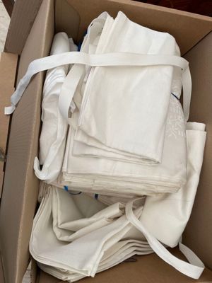 a cardboard box full of white cloths in it