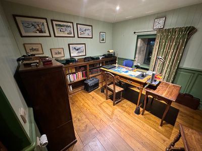 an image of a home office with a desk and bookshelf