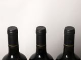 three bottles of wine sitting on top of a table next to each other