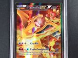 the pokemon card is in a plastic case on a black surface