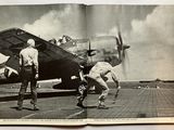 two men that are standing in front of a plane