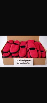 a box full of red slippers with a sign on it