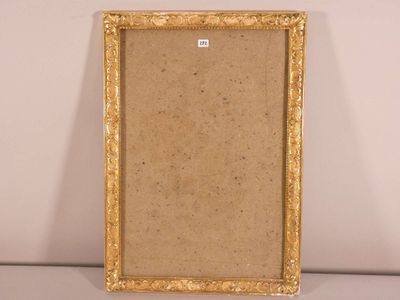 an old picture frame sitting on top of a table next to a wall