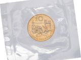 a close up of a coin in a plastic bag on a white background