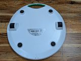 a close up of a white smoke detector on a wooden table
