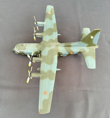 une maquette d'avion militaire posée sur une surface grise