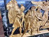 a gold and black marble box on a wooden table