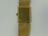 an image of a gold watch with a square face