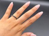 a woman ' s hand with a diamond ring on it