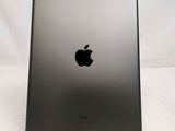 the back of an apple ipad with a black apple logo on it