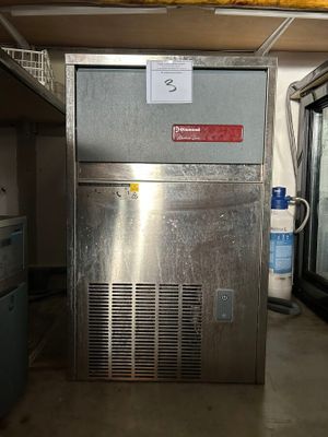 an image of a stainless steel ice machine in a garage