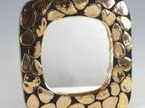 gold and black square shaped mirror with hearts on it
