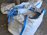 a bag of bags sitting on the ground in front of a building