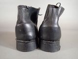 a pair of black boots that are sitting on a table