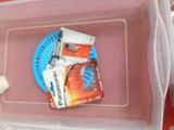 a plastic container with a toothbrush, toothpaste, and toothpaste in it