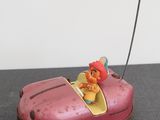 a small toy car with a little girl in it