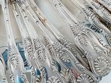 a lot of silver spoons that are on a plate