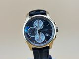 la montre est posée sur un support, sur une surface blanche