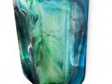a glass vase with a green and blue design on it