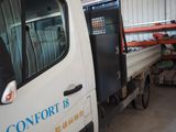 a truck that is parked in a garage with it ' s door open