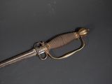 an old sword laying on top of a table with a metal handle