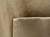 a close up of the pocket of a tan canvas tote bag