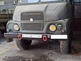 a military truck that is parked in a garage
