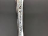 a silver spoon with a silver spoon handle on it