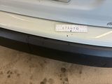 a picture of a car with a sticker on it ' s bumper