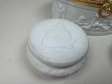 a small white box with a lid sitting on a table