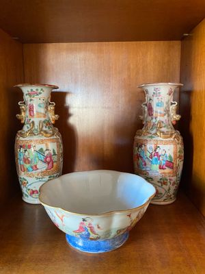 two vases and a bowl sitting on a shelf