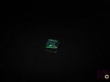 an image of a piece of emerald in the dark