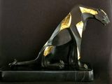 statue of a black cat with gold accents sitting on a black base