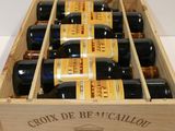 six bottles of wine in a wooden box