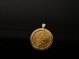 a close up of a gold coin on a black surface