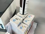boxes of ink sitting on top of a table next to a printer