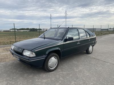 an image of a green car parked in a parking lot