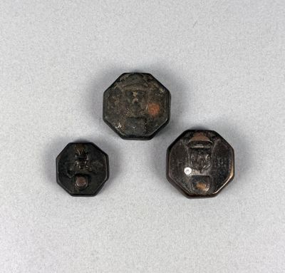 three pieces of metal are shown on a white surface