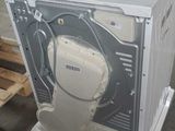 an image of a white dishwasher sitting on top of a pallet in a warehouse